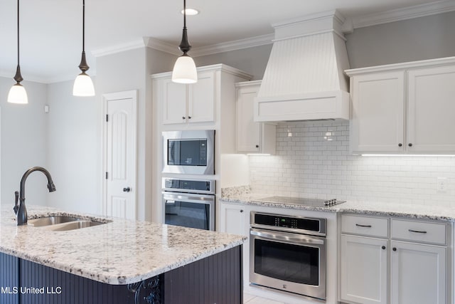 kitchen featuring custom exhaust hood, appliances with stainless steel finishes, ornamental molding, white cabinets, and a sink