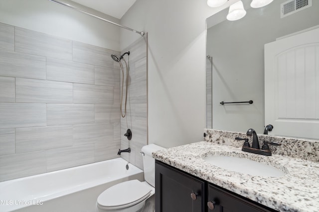 bathroom featuring visible vents, vanity, toilet, and bathing tub / shower combination