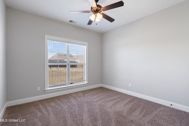 empty room featuring carpet, visible vents, and baseboards