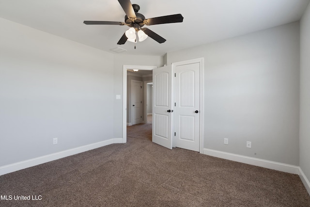 unfurnished bedroom with ceiling fan, carpet floors, a closet, and baseboards