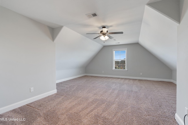 bonus room featuring ceiling fan, visible vents, baseboards, vaulted ceiling, and carpet