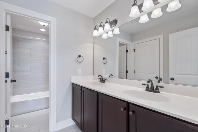 bathroom with shower / washtub combination, a sink, and double vanity