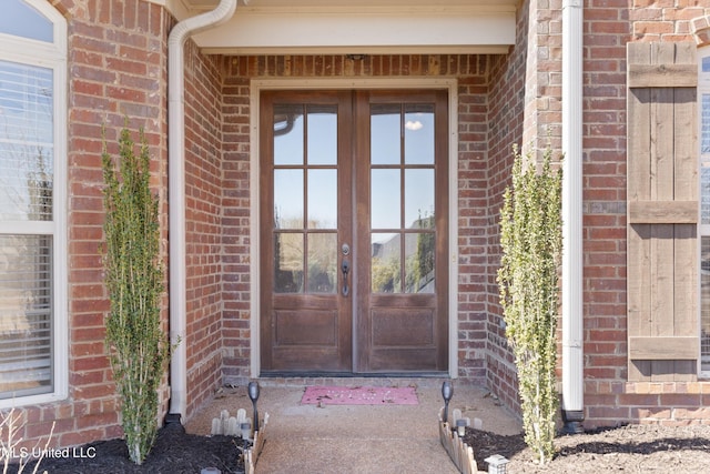 property entrance with french doors and brick siding