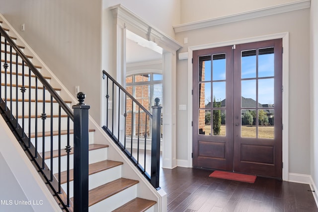 foyer with french doors, baseboards, and dark wood-style flooring