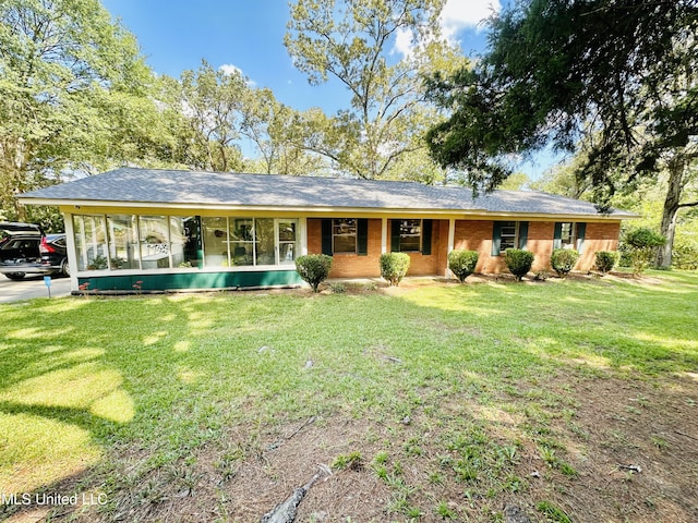 ranch-style home with a front lawn