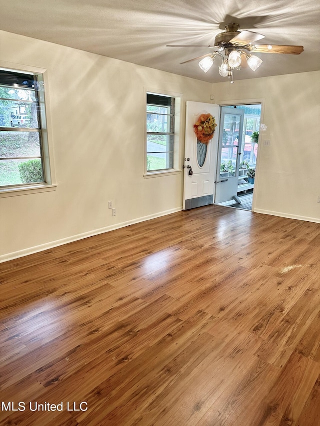 unfurnished room with wood-type flooring and ceiling fan