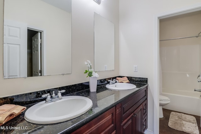 full bathroom with vanity, tub / shower combination, and toilet