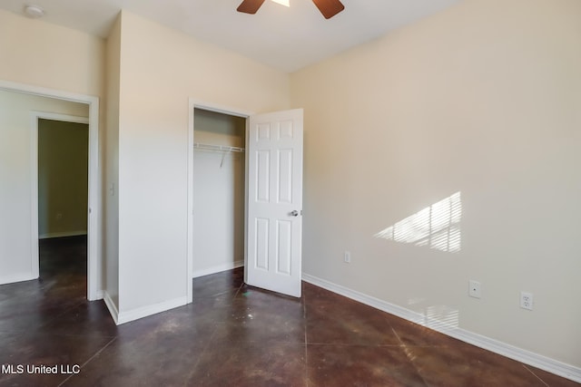 unfurnished bedroom with ceiling fan and a closet