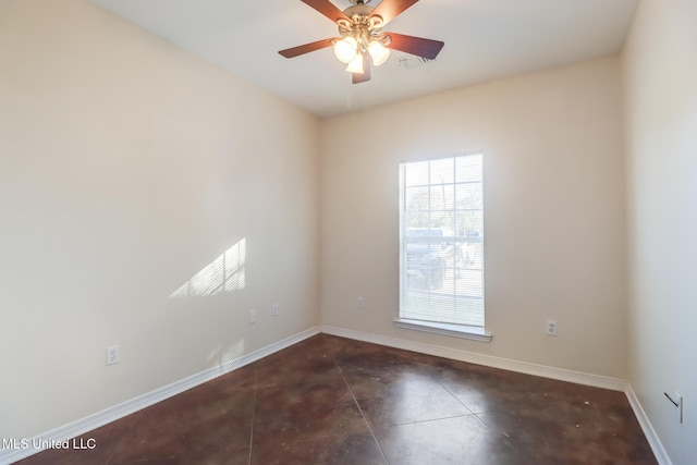 empty room featuring dark tile patterned flooring and ceiling fan