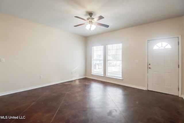 entryway with ceiling fan and dark tile patterned floors