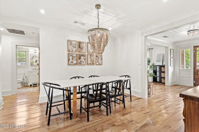 7101 Wayne Ln, Biloxi, MS 39532 - dining space with a chandelier, light wood-style flooring, crown molding, and recessed lighting