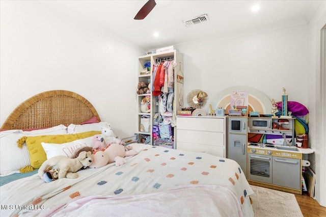 7101 Wayne Ln, Biloxi, MS 39532 - bedroom featuring ornamental molding, light wood-type flooring, and a ceiling fan