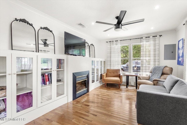 7101 Wayne Ln, Biloxi, MS 39532 - living room with a ceiling fan, a glass covered fireplace, wood finished floors, electric panel, and recessed lighting