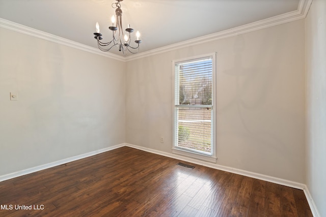 spare room featuring a chandelier, hardwood / wood-style floors, and ornamental molding