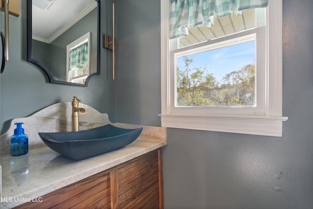 bathroom featuring crown molding and vanity