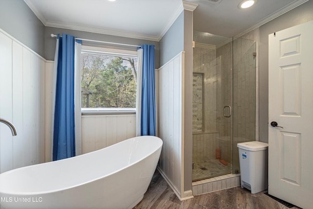 bathroom featuring hardwood / wood-style flooring, shower with separate bathtub, and crown molding