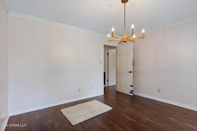 190 Briarwood Dr, Holly Springs, MS 38635 - empty room featuring a chandelier, crown molding, baseboards, and dark wood-type flooring