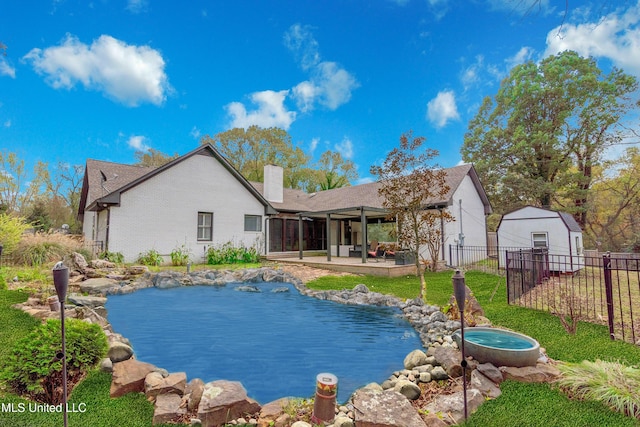 190 Briarwood Dr, Holly Springs, MS 38635 - rear view of house with a chimney, a garden pond, and a patio area