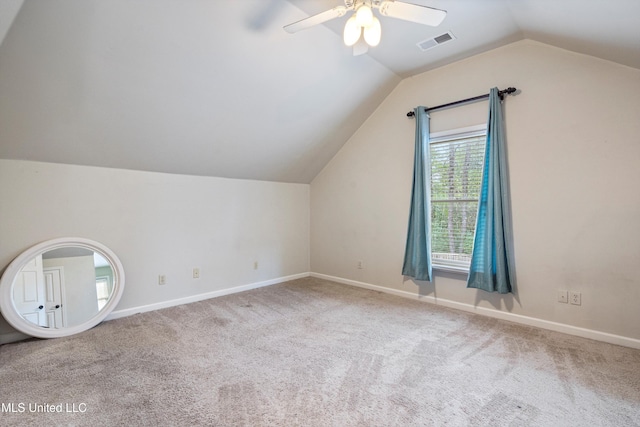 additional living space with light colored carpet, vaulted ceiling, and ceiling fan