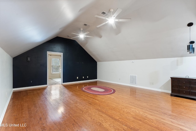 additional living space featuring light hardwood / wood-style floors, vaulted ceiling, and ceiling fan