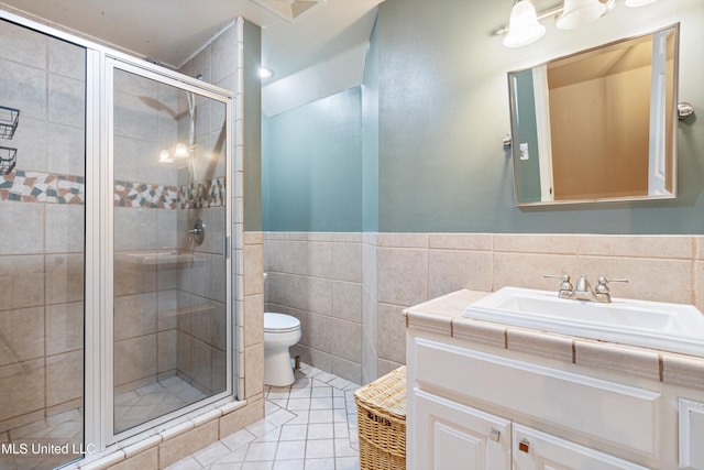 190 Briarwood Dr, Holly Springs, MS 38635 - bathroom featuring tile walls, tile patterned floors, a shower stall, toilet, and vanity