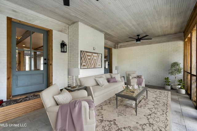 190 Briarwood Dr, Holly Springs, MS 38635 - living room featuring brick wall and ceiling fan