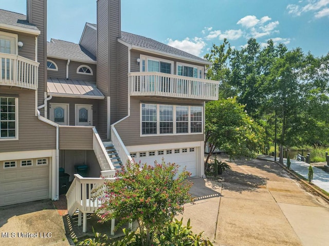 multi unit property featuring a garage and a balcony