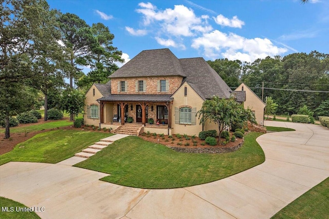 view of front of home featuring covered porch and a front lawn