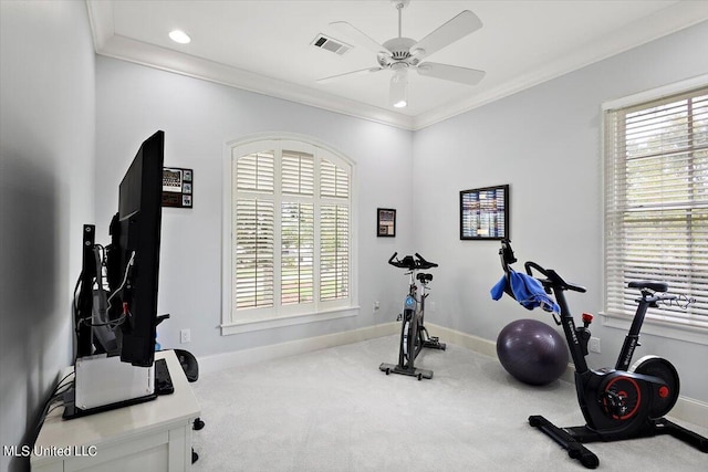 exercise room with ceiling fan, ornamental molding, and light colored carpet