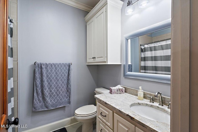 bathroom featuring vanity, crown molding, and toilet