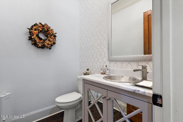 bathroom featuring vanity and toilet