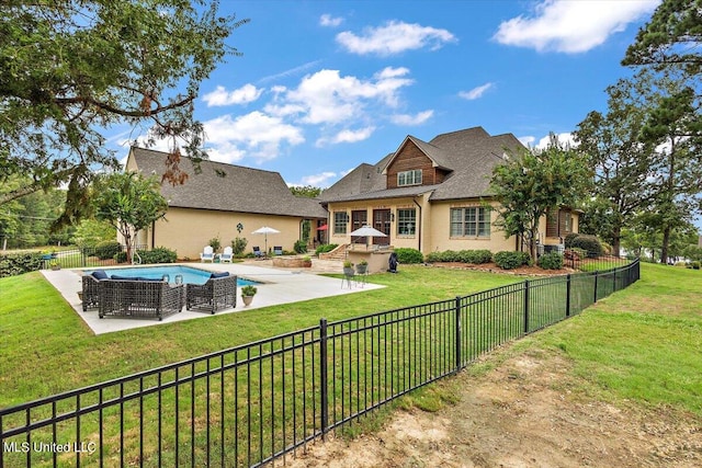 back of house with a patio and a yard