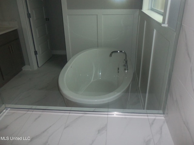 bathroom with vanity and a tub