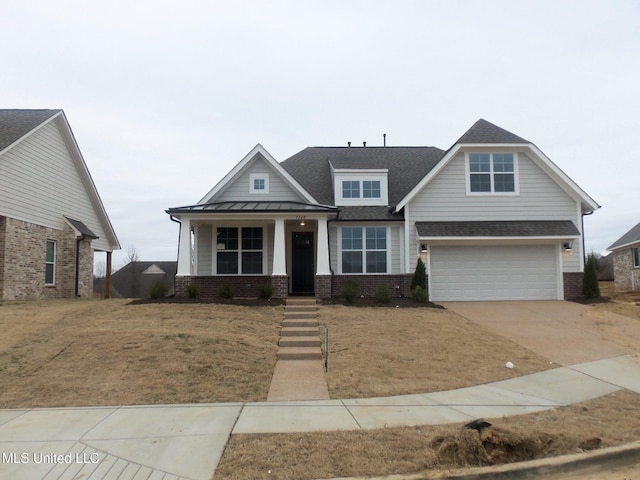 craftsman-style home featuring a garage, a front lawn, and covered porch