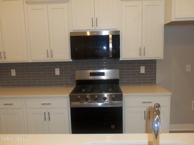 kitchen with white cabinetry, sink, tasteful backsplash, and stainless steel appliances