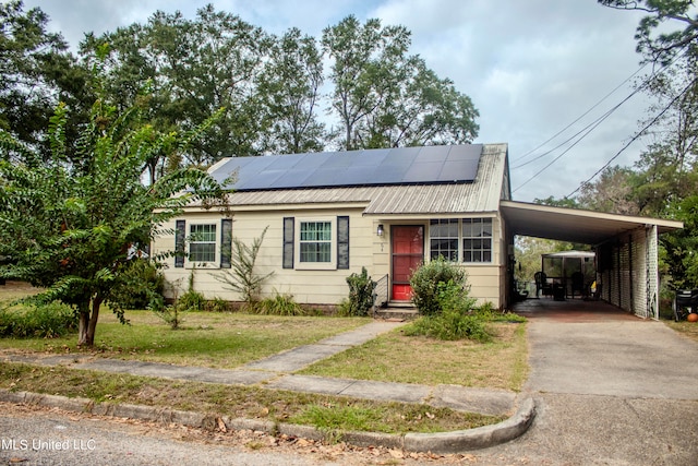 view of front facade with a carport and solar panels