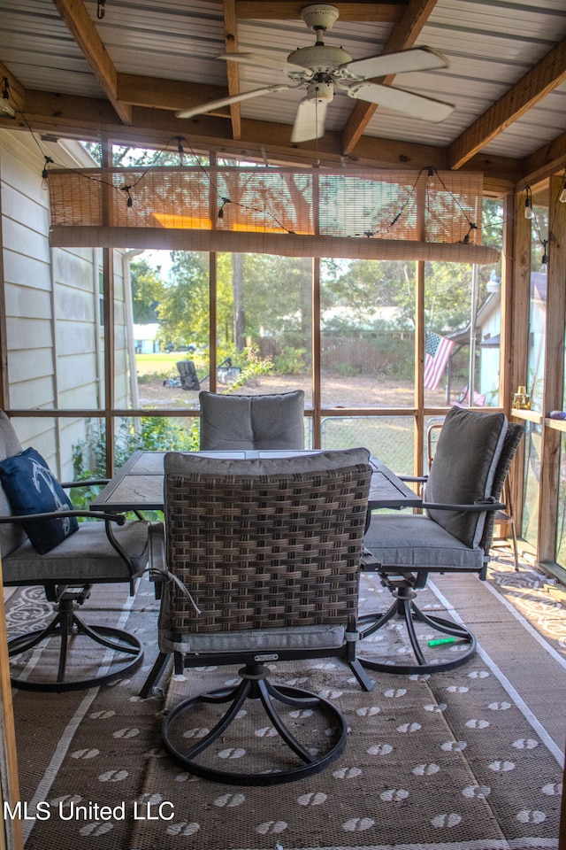 sunroom / solarium featuring ceiling fan, beam ceiling, a wealth of natural light, and wooden ceiling