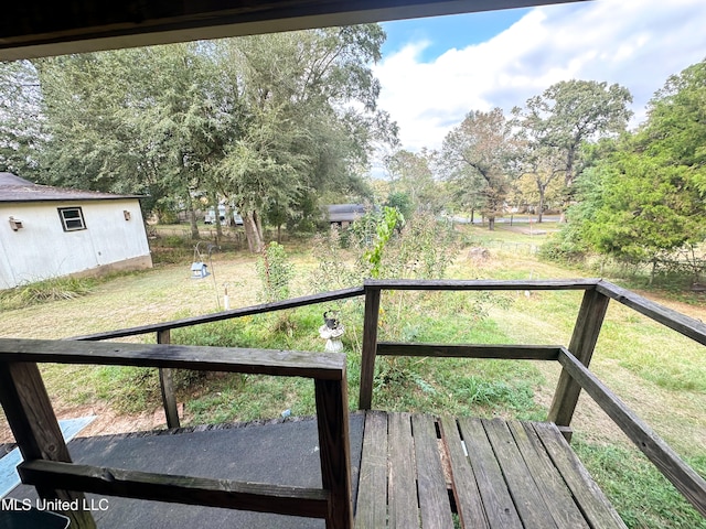 wooden terrace featuring a yard