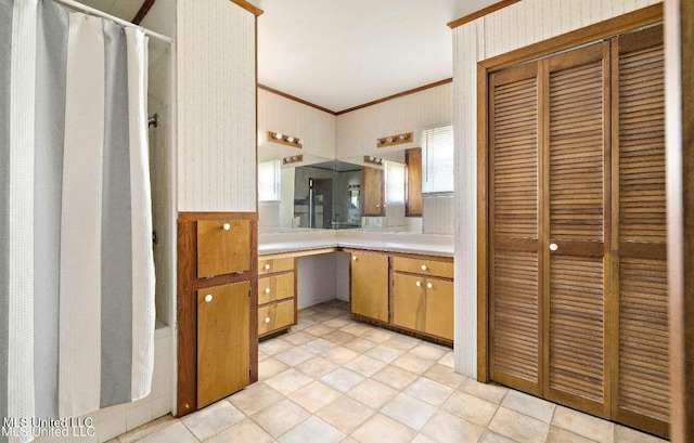 bathroom featuring vanity, crown molding, and a shower with shower curtain