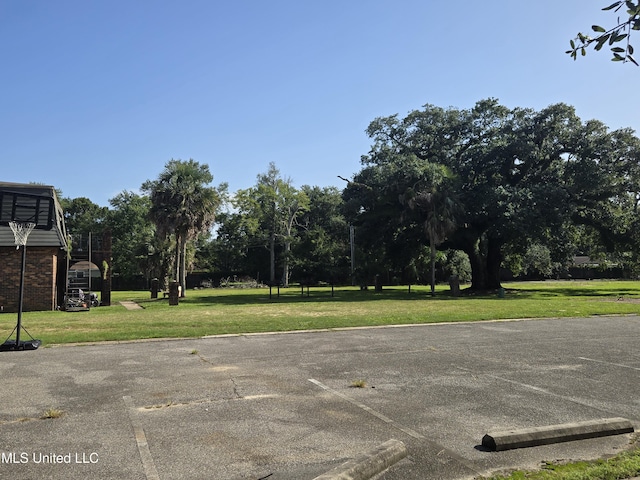 view of parking / parking lot with a lawn