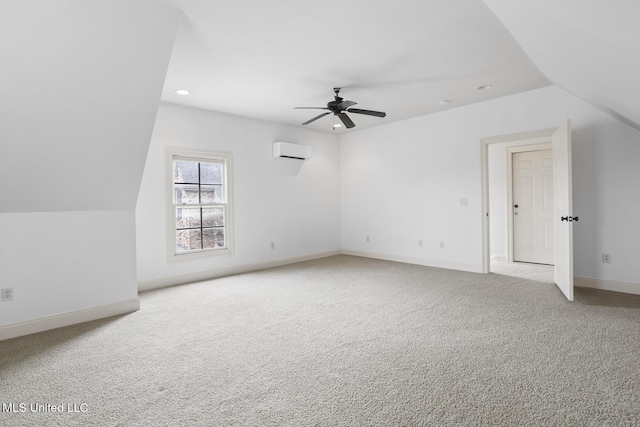 additional living space with ceiling fan, vaulted ceiling, light colored carpet, and a wall mounted AC