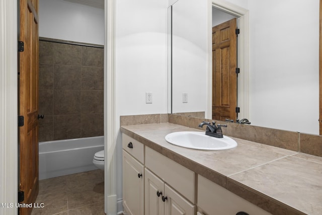 full bathroom with vanity, tiled shower / bath, tile patterned floors, and toilet