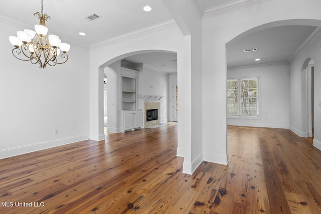 unfurnished living room with crown molding, a fireplace, and dark hardwood / wood-style flooring