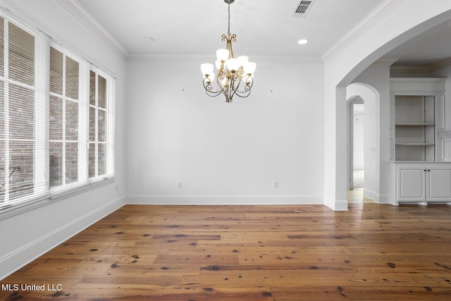 unfurnished dining area with crown molding, dark hardwood / wood-style floors, and a notable chandelier