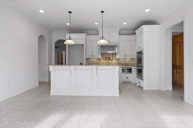 kitchen with pendant lighting, tasteful backsplash, white cabinets, stainless steel appliances, and wall chimney exhaust hood