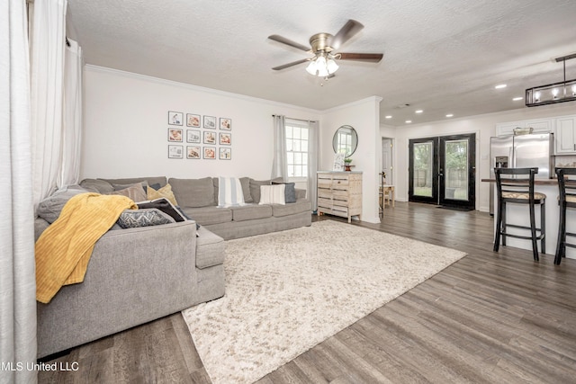 living room with a wealth of natural light, ornamental molding, dark wood finished floors, and recessed lighting