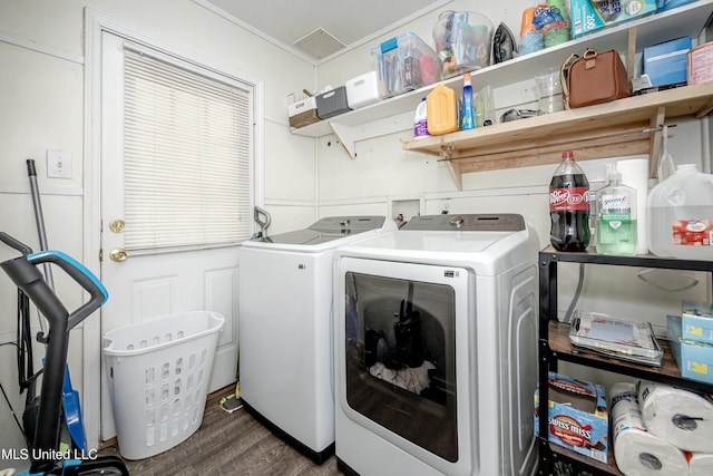 clothes washing area featuring laundry area, independent washer and dryer, and wood finished floors