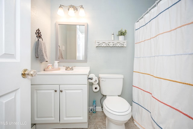 bathroom with toilet, tile patterned floors, vanity, and curtained shower