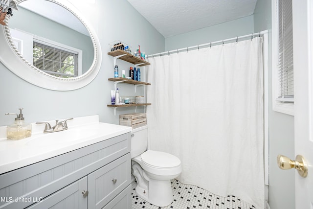 bathroom with a shower with curtain, a textured ceiling, toilet, tile patterned floors, and vanity