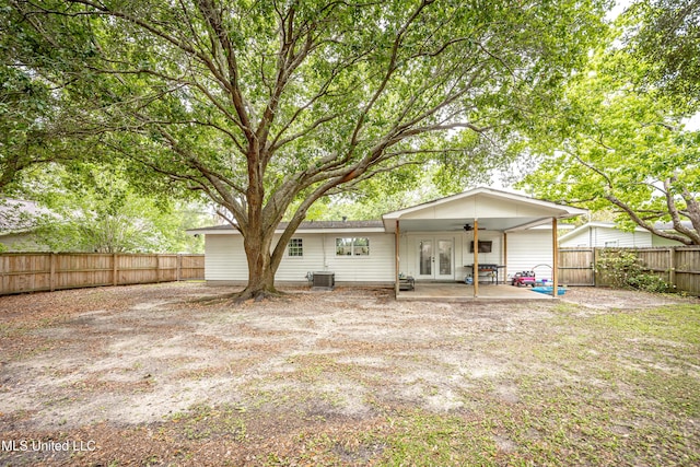 rear view of property featuring a patio, french doors, a ceiling fan, cooling unit, and a fenced backyard